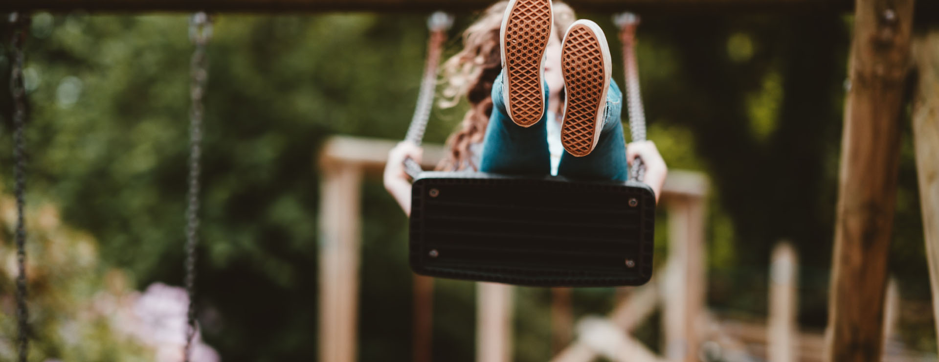 Photo of a girl on a park swing